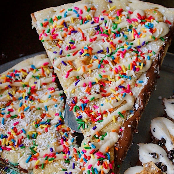 Birthday Cake dessert pizza slice - funfetti cookie dough, cream cheese icing and rainbow sprinkles - Brother Bruno Direct