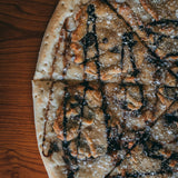 Cookie Dough dessert pizza - vanilla icing, chocolate chip cookie dough and chocolate drizzle - Brother Bruno Direct